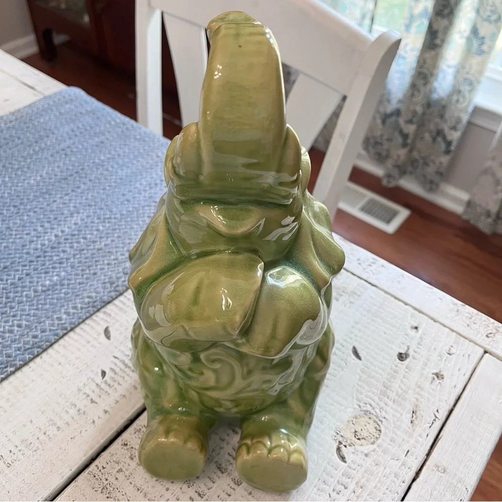 Elephant ceramic- Green Glaze Sitting with Floral Design 10 1/2” euc